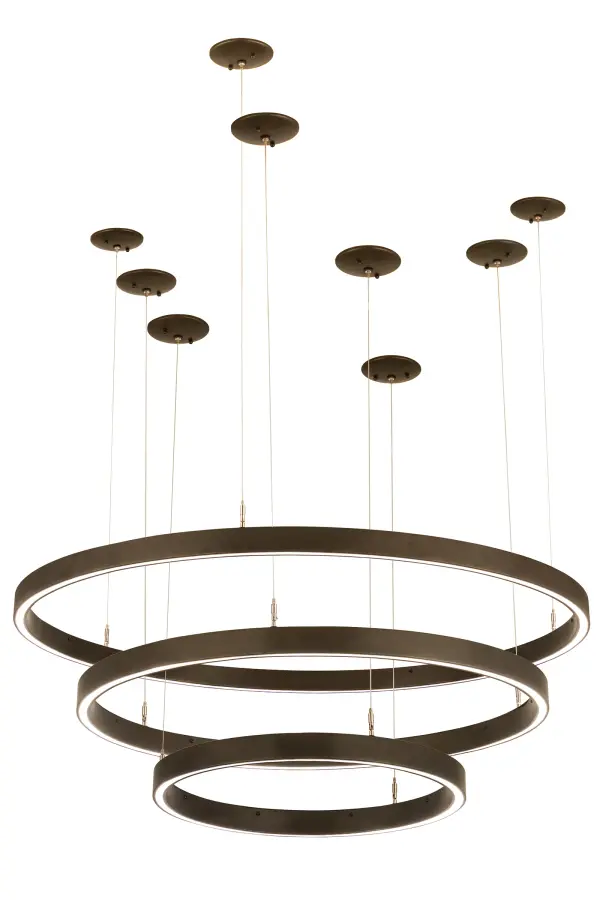 A modern sophisticated pendant featuring 3 spectral halos that create a stunning visual effect and breathtaking drama. Eliminating the power cord, our exclusive proprietary suspension system is engineered with low voltage spacecraft cables for balance, precision and a clean aesthetic. These Mahogany Bronze finished solid rings reveal 3 Statuario Idalight diffusers. Integral LEDs deliver dimmable, robust illumination, energy savings, minimal maintenance and long life. The overall height of this system ranges from 4 to 78 inches as the spacecraft cable length can be easily adjusted in the field to accommodate your specific lighting application needs. Custom sizes, styles and finishes are available. Collection: Anillo Finish: Mahogany Bronze Glass: Statuario Idalight Width: 48.00" Height: 4.00" Length: 48.00" Weight: 44.00 lb Number of Bulbs: 2 Maximum Wattage: 42.00 W Bulb Type: STRIP Bulb Base: INTEGRAL Light Source: LED Color Temperature: 3000 K Material: Steel Country of Origin: USA Safety Listing: Damp Safety Rating: Damp LED