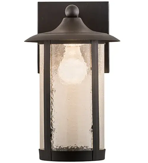 Handcrafted from Solid Brass with alluring rustic beauty. This stunning Craftsman Signature lantern features a Clear Seeded Glass lens enhanced with an Old Wrought. Iron finish. This wall sconce is perfect for illuminating hallways or covered porches of timber homes, modern farmhouses, and other spaces. The Fulton Prime Solid Mount Wall Sconce is included in our American-made, American-designed, handcrafted Craftsman Signature Series, manufactured in Yorkville, New York. UL and cUL listed for dry and damp locations. Our Build Your Own Craftsman Signature Series features unlimited combinations of styles. The collection is called Build Your Own because it is fully configurable and customizable from size and design to finish and lens color. Marine grade, solid brass, or copper raw materials are utilized to ensure items from the Craftsman Signature Series of outdoor and indoor lighting will stand the test of time, as these premium metals are impervious to most types of oxidation. Hand-applied Patina finishes on brass and copper are sealed with a clear varnish and over time, may require gentle maintenance, such as wax, to delay or reverse the natural living finish attributes indicative of this finishing process. Patina finishes on brass and copper provide strong resistance to fading from sun exposure, will not chip or crack, and will not rust like a steel-framed item in the same conditions. Choose from many style options, or send us your concept today! Call today to learn how to use the configuration tool available on our website for an instant item number! Collection: Fulton Finish: Old Wrought Iron Glass: Clear Seeded Glass Width: 8.00" Height: 12.50" Length: 8.00" Weight: 2.50 lb Extension from Wall: 8.00" Number of Bulbs: 1 Maximum Wattage: 60.00 W Bulb Type: A19 Bulb Base: E26 Material: Brass Country of Origin: USA Safety Listing: Damp Safety Rating: Damp - alternate view