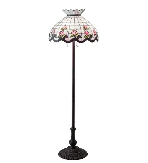 Grace your home with this elegant floor lamp featuring a crowned art glass shade. The shade highlights a gridwork of White Art Glass, adorned with a Mauve Waterglass border of swirling ribbons and perfect Pink rosebuds accented with Green leaves. The stained glass shade is created with the famous Meyda Tiffany copperfoil construction process and complemented with an elegant cast metal floor base in a Mahogany Bronze finish. This lighting design is inspired by famous rose gardens in the New York Botanical Garden in Bronx Park, New York City, to the White House in Washington, D.C. It is ideal for placement in residential and hospitality spaces to create a beautiful design statement. The Roseborder Floor Lamp is featured in our American-designed, handcrafted Stained Glass Lighting Collection. UL & cUL listed for dry locations. Each shade is a unique work of art with color variations based on natural ingredients inherent in the glass. Collection: Roseborder Finish: Mahogany Bronze Glass: Cai Ja Sf Tac Width: 20.50" Height: 62.00" Length: 20.50" Weight: 23.00 lb Number of Bulbs: 3 Maximum Wattage: 60.00 W Bulb Type: A19 Bulb Base: E26 Material: Zinc/Steel Country of Origin: CHINA Safety Listing: Damp Safety Rating: Dry - alternate view