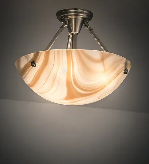 An elegant kiln-formed shade is the result of high-fired; Cognac-colored; swirled art glass. The Metro ceiling fixture; offering hardware in a Brushed Nickel finish; is the perfect centerpiece for any room. Traditional artistry; high-fire kilns; and original tools are used to create art glass in the old-world tradition. The Metro Cognac Swirl Semi-Flush Mount is featured in our American-made; American-designed; handcrafted Art Glass Lighting Collection and manufactured in Yorkville; New York. UL and cUL listed for dry and damp locations. Each shade is a unique work of art with color variations based on natural ingredients inherent in the glass.