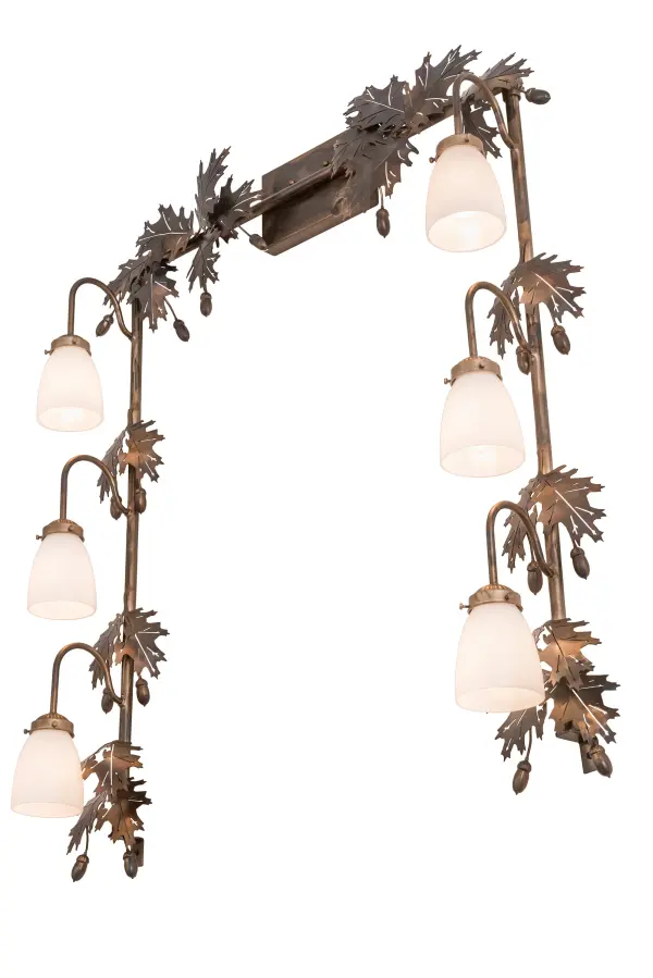 Drawing inspiration from the Mighty Oak; this unique Vanity Light is custom designed to outline a mirror in a fine bath or other rooms. The wall fixture embraces 6 White Opal Goblet styled shades to deliver functional downlighting which is complemented with a Dark Burnished Antique Copper finished Oak Leaf and Acorn accents and frame. Custom crafted in our 180;000 square foot manufacturing facility at the foothills of the Adirondack Mountains in Upstate NY; this wall fixture is available in custom styles; sizes; and colors; and with dimmable energy efficient lamping options such as LED. This 36-inch wide luminaire is UL and cUL listed for dry and damp locations.
