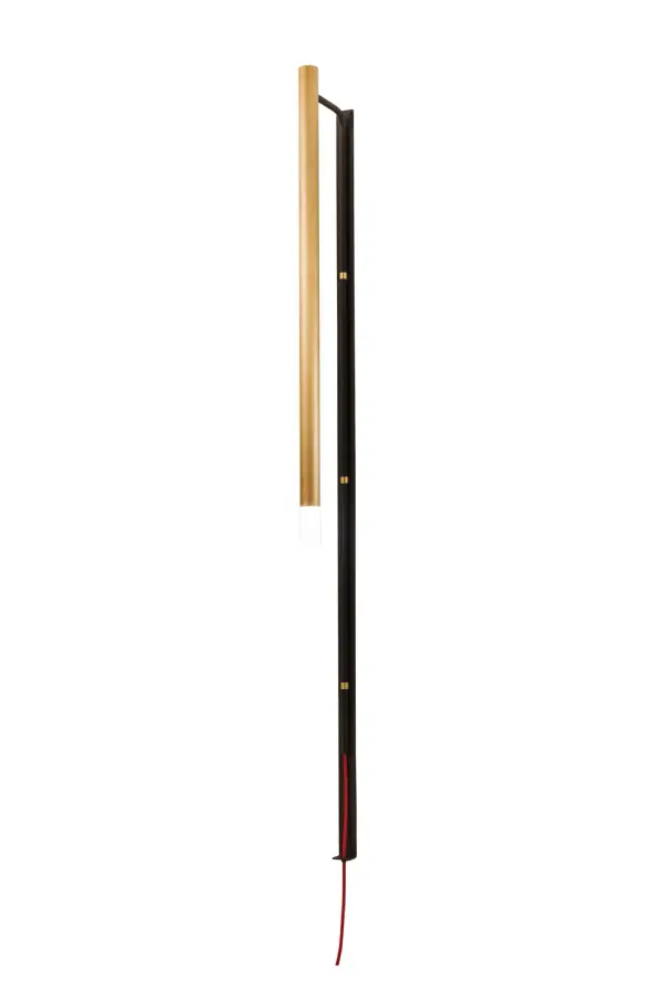 A uniquely suspended cylindrical fixture in a Brushed Brass finish featuring a Contrail Mist Idalight diffuser, this unique, elongated wall sconce includes a Flat Black wall plate with a fancy Red wire. This sconce illuminates with Customer supplied LED lamps. Handmade by highly skilled artisans in our manufacturing facility in Yorkville, NY, this wall luminaire is offered in custom sizes, styles, and finishes. Dimmable energy efficient lamping options such as LED are available. The fixture is UL and cUL listed for dry and damp locations. Collection: Bastone Finish: Flat Black/Natural Brass Glass: Contrail Mist Idalight Width: 1.50" Height: 60.00" Length: 7.25" Weight: 9.00 lb Extension from Wall: 7.25" Number of Bulbs: 1 Maximum Wattage: 2.50 W Bulb Type: TOWER Bulb Base: G9 Light Source: LED Material: Steel Country of Origin: USA Safety Listing: Damp Safety Rating: Damp LED