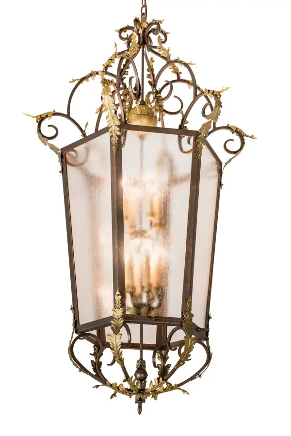 Elegance and charm come to light with this Elisa Pendant as clusters of exquisite Acanthus leaves adorn this stunning lighting design. A Rainstone Idalight lens reveals 12 Amber faux candlelights that deliver beautiful ambient illumination. The decorative accents, frame, and hardware are featured in a Light Tobacco finish with Antique Gold Highlights. The overall height of this pendant ranges from 68 to 140 inches as the chain length can be easily adjusted in the field to accommodate your specific lighting application needs. Handcrafted in our 180,000 sq ft manufacturing facility in Yorkville, NY, this fixture is available in custom colors, styles, sizes and dimmable, energy efficient lamping. UL and cUL listed for dry and damp locations. Collection: Acanthus Finish: Light Tobacco/Antique Gold Glass: Rainstone Idalight Width: 35.00" Height: 68.00" Length: 35.00" Weight: 78.00 lb Number of Bulbs: 12 Maximum Wattage: 60.00 W Bulb Type: BA9 Bulb Base: E12 Material: Steel Country of Origin: USA Safety Listing: Damp Safety Rating: Damp