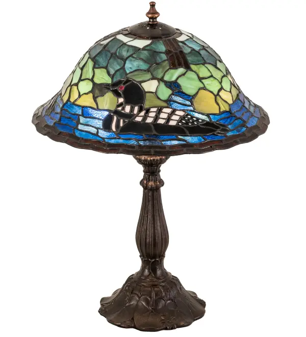 Listen to the melodious calls of this Black and White Loon echo across the mountain lake as this aquatic bird wades on the Blue Art Glass water. Beautiful ambient light evokes from this resplendent Art Glass shade; which is created using the famous Meyda Tiffany copper foil construction. The stunning shade is complemented with an appealing base featured in a Mahogany Bronze finish. Custom sizes; styles; and colors are available; as well as dimmable energy efficient lamping options such as LED. The 19-inch tall table lamp is UL and cUL listed for dry locations.