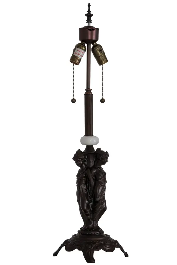 This slender table base features intricate metal statuettes of three Greek goddesses; including Aglaea (splendor); Euphrosyne (mirth); and Thalia (good cheer); who embody charm; beauty; nature; human creativity; and fertility. Daughters of Zeus; they symbolize joy; youth; and the harmonious; intertwined nature of grace and beauty in art and life. The Mahogany Bronze decorative base features White Onyx accents and is perfect for embracing a single shade crafted from stained glass and other fine materials; and ranging in width from 18 to 24 inches. Two traditional pull chains are available to illuminate one bulb or both. The Three Graces 2 Light Table Base is included in our American-made; American-Designed handcrafted Decorative Floor Base collection; manufactured in Yorkville; New York. The base is UL and cUL listed for dry locations.