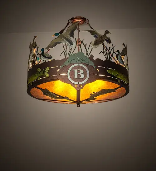 Ducks splash and fly above the marsh in this wildlife inspired fixture. Custom handpainted Ducks; Pike and Reeds are designed above the Amber Mica diffuser which is accented with handpainted Bass silhouettes. The fixture is personalized with the laser-cut The Boulders Cooperstown; NY name and Black handpainted logo. Hardware is featured in a New Copper Vein finish. UL and cUL listed. This personalized item is shown as an example of our craftsmanship and custom capabilities. This item is not for sale as is" but can be customized to fit your business or family needs. "