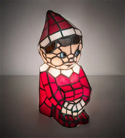 Warm your heart and imagine Santa's Helper on your shelf or over the mantle. A charming lighted Tiffany styled sculpture; Santa's Helper comes to light as a colorful accent lamp. The Elf is adorned in an exquisite outfit featured in Red art glass with White glass trim. Facial features include Blue glass eyes and other complementary attributes. Handcrafted of individual pieces of stained glass using the famous Meyda Tiffany copperfoil construction process. UL and cUL listed for dry and damp locations.
