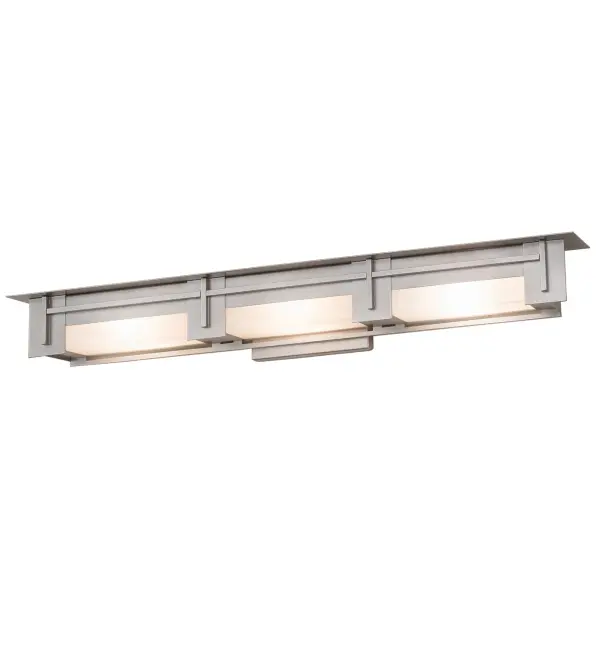 An architecturally styled wall luminaire. The Konsol wall sconce features three Statuario Idaight lenses embraced by a sturdy frame with hardware finished in a Nickel powder coat. This luminaire is ideal as a wall sconce in any room or as a vanity light in a fine bath. Custom crafted in our 180,000 square foot manufacturing facility in Yorkville, NY. Available in custom sizes, finishes, and styles. Dimmable energy efficient lamping options are offered. UL and cUL listed for dry and damp locations. Collection: Konsol Finish: Nickel Glass: Statuario Idalight Width: 42.00" Height: 6.00" Length: 5.00" Weight: 20.00 lb Extension from Wall: 5.00" Number of Bulbs: 3 Maximum Wattage: 3.00 W Bulb Type: A19 Bulb Base: G9 Light Source: LED Material: Steel Country of Origin: USA Safety Listing: Damp Safety Rating: Damp LED