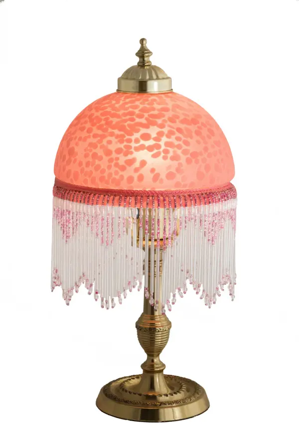 A charming nostalgic mini lamp that doubles as a decorative accent for nearly any room. This Roussillon Mini Lamp features a stunning Cranberry Mottled Glass shade that is color coordinated with delicate White and Cranberry glass beaded fringe. This Victorian-inspired shade is combined with a beautifully detailed lamp base in a Brass plated finish. The Roussillon Mini Lamp is featured in our American designed, handcrafted Victorian Lighting Collection. UL and cUL listed for dry locations. Each shade is a unique work of art with color variations based on natural ingredients inherent in the glass. Contact us if color matching is critical when ordering multiple items. Collection: Roussillon Finish: Mahogany Bronze Glass: Pink,Gold Width: 8.00" Height: 15.00" Length: 8.00" Weight: 3.50 lb Number of Bulbs: 1 Maximum Wattage: 60.00 W Bulb Type: A19 Bulb Base: E26 Material: Brass Country of Origin: CHINA Safety Listing: Dry Safety Rating: Dry