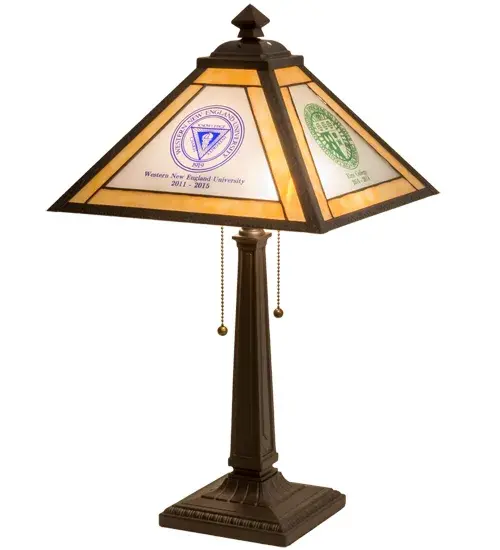 Designed with the names and logos of three educational institutions Clinton High School; Western New England University; and Elms College- this handsome art glass lamp features Beige; Red; and Blue art glass in its shade. The Brass lamp offers Craftsman Brown and Mahogany Bronze finishes. The Personalized Graduation Present Table Lamp is included in our American-made; American-designed; handcrafted Personalized Lighting Collection and manufactured in Yorkville; New York. The lamp is UL listed for dry locations. This art glass shade can be ordered; and we will coordinate the custom logo with you to suit your project. Call for pricing and lead time. - alternate view