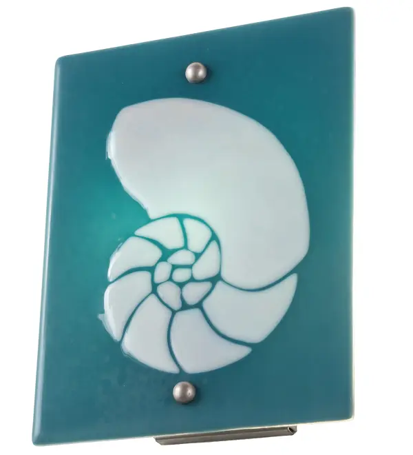 Hot high-fired glass is transformed into a cool abstract lighting design; blending a Clear Frosted Seashell design on a Dusty Blue Art Glass background. Striking fused glass defines this extraordinary sconce; which is ideal for illuminating a wide range of rooms in homes; resorts; hotels; and restaurants. Complement this fixture with the Metro Fusion Nautilus Right Wall Sconce; model 284093; to create a complete design statement. The Metro Fusion Nautilus Wall Sconces are ADA-compliant and featured in our American-made; American-designed; handcrafted Modern Lighting Collection. Both fixtures are manufactured in Yorkville; New York. UL and cUL listed for dry and damp locations. Each shade is a unique work of art; featuring color variations derived from the natural ingredients inherent in the glass. The Quality Bent Glass division of Meyda Tiffany Lighting has been in the making for over 100 years. Today; we continue to create timeless masterpieces using tools and methods that date back to the days when we supplied Tiffany Studios. Fused glass colors and metal finishes are customizable; as each fixture is handcrafted to order.
