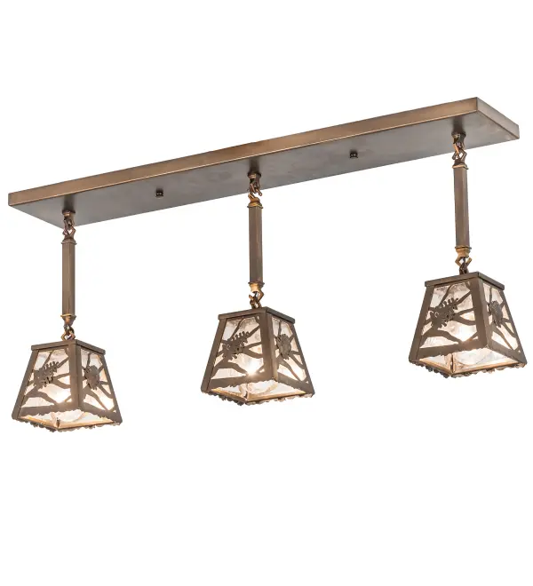 Listen closely. You can almost hear the soft whisper of the pine branches as they dance in the wind. Enjoy the ambiance of soft beautiful light diffused through three Clear Seeded Glass shades featuring stunning Pinecone and Pine Branch designs. This linear ceiling pendant is featured in an Antique Copper finish. Ideal for illuminating kitchen islands; billiard/dining tables; counters and bars. Handcrafted by highly skilled artisans in our 180;000 square manufacturing facility in Yorkville; New York. Shade colors; metal finishes and sizes can be customized. UL and cUL listed for dry and damp locations.