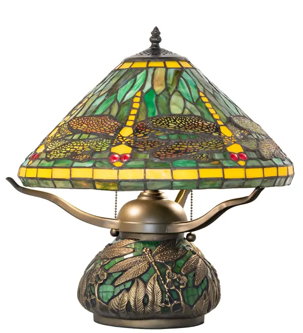 Recreating Tiffany Studio's most beloved stained glass design, this stunning lamp is modeled after the original dragonfly design. Diving dragonflies with glowing Scarlet jeweled eyes and delicate metal filigree wings circle over hand-cut and copperfoiled pieces of Amber and Green art glass. The elegant cast base features hand-applied Mahogany Bronze finished Dragonflies with leaves on Green art glass tiles.The lamp is ideal as an illuminating accent piece for credenzas, occasional tables, and other spaces in residential and hospitality settings. Inspired by dragonflies found in marshes and ponds throughout the US, from the Florida Panhandle and Everglades, to southeast Wisconsin, to the Alaska wetlands. The Tiffany Dragonfly Table Lamp is included in our American-designed Tiffany Reproduction Lighting Collection. UL and cUL listed for dry locations. Each shade is a unique work of art with color variations based on natural ingredients inherent in the glass. Please let us know if color matching is critical when ordering multiple items. Collection: Tiffany Dragonfly Finish: Timeless Bronze Glass: Stained Glass Green Mosaic Glass Width: 16.00" Height: 16.00" Length: 16.00" Weight: 9.00 lb Number of Bulbs: 2 Maximum Wattage: 60.00 W Bulb Type: A19 Bulb Base: E26 Material: Steel/Glass Country of Origin: CHINA Safety Rating: Dry