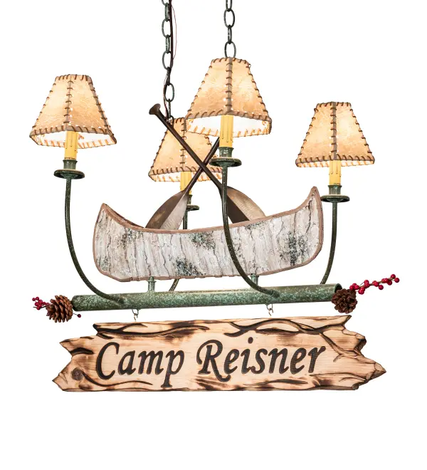 This handsome 4-light chandelier; complete with Antique Copper finished steel paddles; is the perfect complement to your camp; home; lodge or cabin. Camp Reisner is custom engraved with a hot iron branding on the attached signage. This charming fixture features a faux birch bark Canoe; surrounded by four curved arms with Faux Leather shades that top Ivory faux candlelights on bobeches. The hardware includes Tarnished Copper finished arms and frame. The chandelier is ideal for illuminating a bar; island; counter; or table. This luxurious fixture is perfect for illuminating bars; dining tables; lobbies; entryways; and other residential; hospitality; and commercial spaces throughout the U.S.; including Greenville; Maine; Wolfeboro; New Hampshire; and Lake Havasu City; Arizona. The Personalized Canoe 4 Light Chandelier is featured in our American-made; American-designed; handcrafted Personalized Lighting Collection. UL & cUL listed for dry and damp locations. Please provide us with your family name so we can develop lighting fixtures that bring joy and pride to your home. Call us for pricing and lead time.
