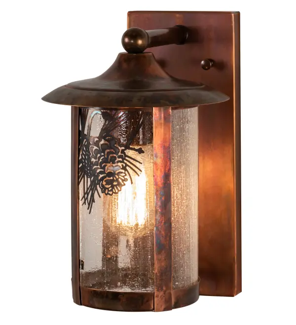 Pinecones and pine needles are delicately etched of Solid Copper. This compelling design represents the iconic symbol of spiritual enlightenment and eternal life. Natural charm comes alive with ambient light shining through a Clear Seeded Glass Lens. The wall sconce is enhanced with a Vintage Copper finish. This Craftsman Signature cylindrical shaped fixture is perfect for various indoor and outdoor lighting applications. Handcrafted by master artisans in our 180,000 square foot manufacturing facility in Yorkville, New York. Shade colors, metal finishes and sizes can be customized to meet your needs. UL and cUL listed for dry, damp and wet locations. Collection: Fulton Finish: Vintage Copper Glass: Clear Seeded Glass Width: 8.00" Height: 12.50" Length: 10.50" Weight: 4.00 lb Extension from Wall: 10.50" Number of Bulbs: 1 Maximum Wattage: 60.00 W Bulb Type: A19 Bulb Base: E26 Material: Copper Country of Origin: USA Safety Listing: Wet Safety Rating: Wet