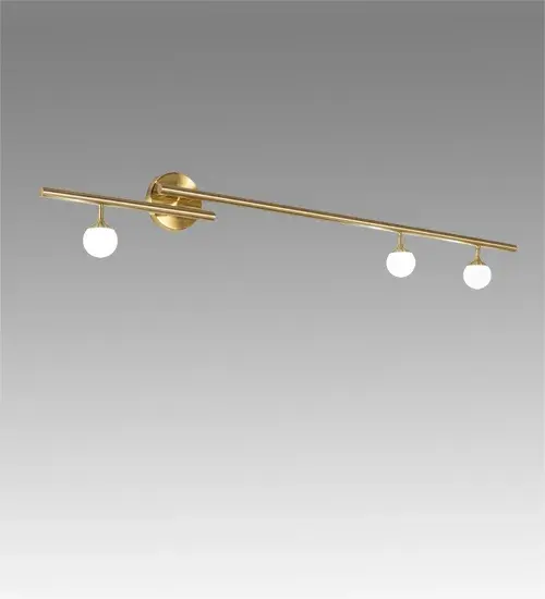 This architectural lighting fixture is designed with a unique and stylish design. Suspended from this wall sconce are three Matte White Art Glass Orbs that are enhanced with a Brushed Waxed Brass frame. The elaborate geometric structure features decorative elements and is ideal for placement in corridors and other spaces where you want to make a dramatic design statement in residential and hospitality settings. It can also be used as a vanity light in fine powder rooms. Perfect in areas nationwide; from Detroit; Michigan; to Louisville; Kentucky; to Sacramento; California. The 60" Wide Bola 3 Light Wall Sconce is included in our American-designed; handcrafted Modern Lighting Collection. UL and cUL listed for dry and damp locations. - alternate view