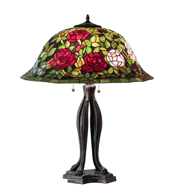 The most beloved of all floral beauties. The Rosebush is beautifully represented in this stunning reproduction of a Tiffany Studio Classic. Petal Pink, Romantic Red and Beautiful Blue art glass Roses ramble on a maze of Garden Green leaves. The shade is created using the famous Meyda Tiffany copperfoil construction. The delicate domed stained glass shade is paired with a Mahogany Bronze finished base. UL and cUL listed for dry locations. Collection: Tiffany Rosebush Finish: Mahogany Bronze Glass: Stained Glass Width: 24.00" Height: 30.00" Length: 24.00" Weight: 17.50 lb Number of Bulbs: 3 Maximum Wattage: 60.00 W Bulb Type: A19 Bulb Base: E26 Material: Zinc/Steel Country of Origin: CHINA Safety Rating: Dry