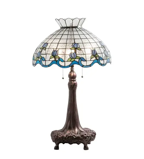 Grace your home with the elegant Roseborder Table Lamp. This lamp features an exquisitely crowned shade featuring a gridwork of Clear Crackle Glass adorned with a Blue Art Glass border of swirling ribbons and perfect Blue Rosebuds with Green Leaf accents. The shade is made of hand-cut art glass using the famous Meyda Tiffany copperfoil construction process and embraced by a lamp base finished in Mahogany Bronze. The Roseborder Table Lamp is featured in our American-designed, handcrafted Stained Glass Lighting Collection. UL and cUL listed for dry locations. Each shade is a unique work of art with color variations based on natural ingredients inherent in the glass. Contact us if color matching is critical when ordering multiple items. Collection: Roseborder Finish: Mahogany Bronze Glass: Stained Glass Width: 20.00" Height: 32.00" Length: 20.00" Weight: 14.50 lb Number of Bulbs: 3 Maximum Wattage: 60.00 W Bulb Type: A19 Bulb Base: E26 Material: Steel/Zinc Country of Origin: CHINA Safety Rating: Dry - alternate view