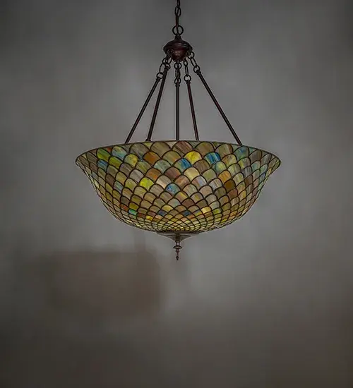 A Louis Comfort Tiffany studio classic. The famous Fishscale design features Honey dripped Emerald; Sapphire; Purple; Mauve; and Garnet colored art glass; evoking a unique dimensional and textured look in a rainbow of brilliant hues. This exquisite variegated art glass shade which is created using the famous Meyda Tiffany copperfoil construction process. The inverted shade is complemented with a Mahogany Bronze hand finished hardware. The overall height ranges from 32 to 67 inches as the chain length can be easily adjusted in the field. UL and cUL listed for dry and damp locations. We cannot depict every color variation but if you are looking for a specific color; call customer service for an updated image of current stock.