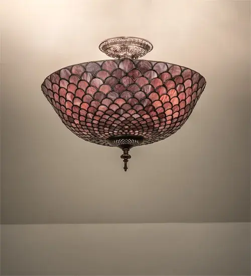 A Louis Comfort Tiffany studio classic... The renowned Fishscale design features a variegated Tortoiseshell of Emerald; Sapphire; Mauve; and Beige colored art glass; evoking a unique dimensional and textured look in a rainbow of brilliant hues. This exquisite art glass shade is created using the famous Meyda Tiffany copperfoil construction process and enhanced with a Mahogany Bronze finish. Inspired by Rainbow Trout and other colorful fish found in Northwest Montana; Eastern Idaho; and Baja; California. The ceiling fixture can perfectly illuminate living and dining spaces in residential and hospitality settings. The Tiffany Fishscale Flushmount is included in our American-designed Tiffany Reproduction Lighting Collection. UL and cUL listed for dry and damp locations. Each shade is a unique work of art with color variations based on natural ingredients inherent in the glass. Custom made. Call for price and lead time.