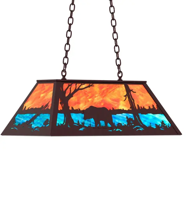 A Black Bear wanders by a lake in the woods on this nature inspired oblong pendant. Beautiful ambient illumination shines brilliantly across a Sunburst colored art glass sky above gleaming Blue-Green glass waters. Mahogany Bronze finished hardware and accents complement this oblong pendant. Perfect for lighting a kitchen island, bar, billiard table, or other space Overall height ranges from 18 to 43 inches as the chain length can be easily adjusted in the field to accommodate your specific lighting needs. Made to Order in our 180,000 sq ft facility at the foothills of the breathtaking Adirondack Mountains. Shade colors, metal finishes and pendant sizes can be customized to meet your needs. UL and cUL listed for damp and dry locations. Collection: Bear At Lake Finish: Mahogany Bronze Glass: Oa Eb Width: 17.00" Height: 19.00" Length: 33.00" Weight: 30.00 lb Number of Bulbs: 6 Maximum Wattage: 60.00 W Bulb Type: A19 Bulb Base: E26 Country of Origin: USA Safety Rating: Damp