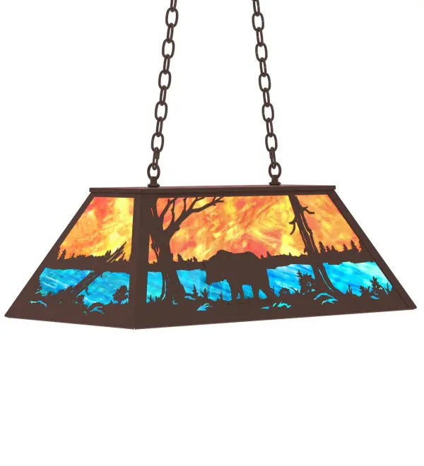 A Black Bear wanders by a lake in the woods on this nature inspired oblong pendant. Beautiful ambient illumination shines brilliantly across a Sunburst colored art glass sky above gleaming Blue-Green glass waters. Cafe Noir finished hardware nicely complement this oblong pendant. Perfect for lighting a kitchen island, counter, bar, billiard table or other space. Overall height ranges from 18 to 43 inches as the chain length can be easily adjusted in the field to accommodate your specific lighting needs. Made to Order in our 180,000 sq ft facility at the foothills of the breathtaking Adirondack Mountains. Shade colors, metal finishes and pendant sizes can be customized to meet your needs. UL and cUL listed for damp and dry locations. Collection: Bear At Lake Finish: Cafe Noir Glass: Orange And Blue Art Glass Width: 17.00" Height: 18.00" Length: 33.00" Weight: 30.00 lb Number of Bulbs: 6 Maximum Wattage: 60.00 W Bulb Type: A19 Bulb Base: E26 Material: Steel Country of Origin: USA Safety Rating: Damp