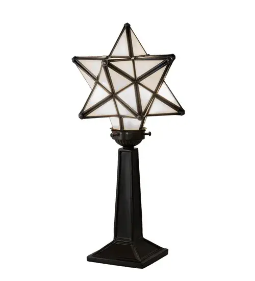 Like wishing upon a magical star in the sky, grace the interior of your home with this timeless accent lamp. Dating back hundreds of years in Europe, the Star was used to protect homes and bring good luck to families. This unique lamp features a Star-style White Glass shade, which is created with a dozen points of light. A Timeless Bronze finish complements the stunning shade, which is made using the famous Meyda Tiffany Brass Channel Construction technique. The lamp is ideal for illuminating picture windows and desks in fine residences, restaurants, and hotels. The Moravian Star Accent Lamp is part of our American-designed, handcrafted Moravian Star Collection. The fixture is UL and cUL listed for use in dry locations. Collection: Moravian Star Finish: Timeless Bronze Glass: White Width: 7.50" Height: 16.50" Length: 7.50" Weight: 3.50 lb Number of Bulbs: 1 Maximum Wattage: 60.00 W Bulb Type: B10 Bulb Base: E12 Material: Steel Country of Origin: CHINA Safety Rating: Dry - alternate view