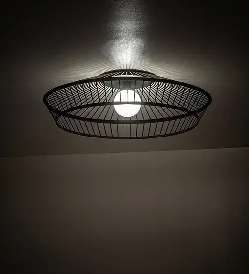 Discover a unique decorative look featuring an industrial lighting design that reveals an exposed Contrail Mist Idalight Orb lamp that illuminates from within this ceiling fixture. The custom-crafted luminaire features a Solar Black Weave-Tex caged frame. The fixture is perfect for illuminating hallways and living spaces in homes and hotels from Shreveport; Louisiana; to Aurora; Illinois; to Moreno Valley; California. The Cilindro Golpe Flushmount is included in our American-made; American-designed handcrafted Industrial Lighting Collection and manufactured in Yorkville; New York. It is UL & cUL listed for dry and damp locations.