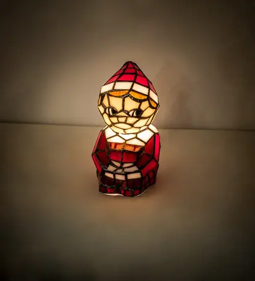 Warm your heart and imagine Santa's Helper on your shelf or over the mantle. A charming Tiffany styled sculpture; Santa's Helper comes to light as a colorful mini lamp. The Elf is adorned in an exquisite outfit featured in Red art glass with White glass trim. Facial features include Blue glass eyes and other complementary attributes. Handcrafted of individual pieces of stained glass using the famous Meyda Tiffany copperfoil construction process. UL and cUL listed for dry locations. The Elf Mini Lamp is included in our American designed; handcrafted Stained Glass Lighting Collection. UL & cUL listed for dry locations. Each lighted sculpture is a unique work of art with color variations based on natural ingredients inherent in the glass.