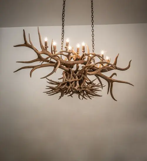 A stunning; massive Antler design comes to light. Capture the rustic charm of naturally shed; hand-selected Antlers with this chandelier. No animals are harmed; and all Antlers are 100 percent authentic. This stunning chandelier is adorned with 10 complementary faux candlelights that cast beautiful ambient light. The fixture is enhanced with an Antique Copper finish. The overall height range is 33 to 64 inches and can be easily adjusted on location; additional chain can be requested upon ordering. This fixture is ideal for illuminating islands; bars; and dining tables. The Antlers Oblong Chandelier is featured in our American-manufactured; American-designed Antlers Lighting Collection and is made in the United States. The fixture is UL and cUL listed for dry and damp locations; and is handcrafted using sustainably harvested; naturally shed Antlers. No two antlers are precisely alike; and natural variations may be expected from each one-of-a-kind piece.