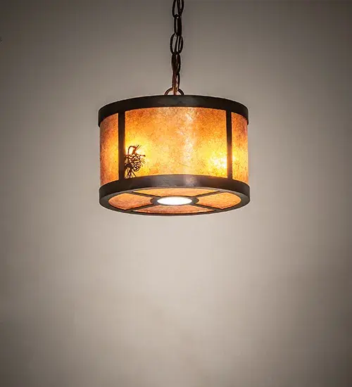 This stunning cylindrical lantern features an Amber Mica lens design; a Winter Pine motif; and is enhanced with a Dark Burnished Antique Copper finish. The pendant is perfect for illuminating islands and dining tables in timber homes; modern farmhouses; and other spaces. The fixture features two circuits: one for the two inner lights that highlight the beauty of the mica; and the second for the downlight used for functional illumination on surfaces below. The overall height ranges from 12 to 41 inches; as the chain can be easily adjusted on location. The Fulton Winter Pine Pendant is part of our American-made; American-designed; handcrafted Craftsman Collection; manufactured in Yorkville; New York. UL and cUL are listed for use in both dry and damp locations.