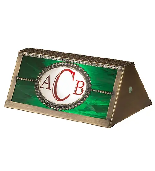 A stunning Brass Banker's Lamp shade is personalized with the monogram ACB in Red. The shade features Emerald art glass and is complemented with an Antique Brass finish. It pairs well with a base to create a banker's lamp. The Personalized Banker's Shade is included in our American-made; American-designed; handcrafted Personalized Collection and manufactured in Yorkville; New York. This specific shade can be ordered; and we will coordinate the custom logo with you to suit your project. Call For Lead Time and Pricing. - alternate view