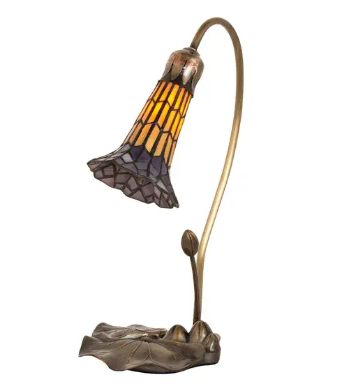 Inspired by Tiffany's famous Pond Lily design from the early 1900s... This mini lamp is created with Honey and Purple art glass using the famous Meyda Tiffany copperfoil construction. The Pond Lily shade is embraced by an elegant cast base finished by hand in Antique Brass. The Pond Lily Mini Lamp is featured in our American designed, handcrafted Stained Glass Lighting Collection. UL and cUL listed for dry locations. Each shade is a unique work of art with color variations based on natural ingredients inherent in the glass. Contact us if color matching is critical when ordering multiple items. Collection: Stained Glass Pond Lily Finish: Mahogany Bronze Glass: Honey Wispy & Purple Width: 8.00" Height: 16.00" Length: 8.00" Weight: 3.00 lb Maximum Wattage: 40.00 W Bulb Type: B10 Bulb Base: E12 Material: Steel Country of Origin: CHINA Safety Rating: Dry - alternate view