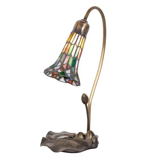 Inspired by Tiffany's famous Pond Lily design from the early 1900s... This mini lamp features a stunning multicolored stained glass shade created using the famous Meyda Tiffany copperfoil construction process. The Pond Lily shade is embraced by an elegant Cast Base hand finished in Antique Brass. The Pond Lily Table Lamp is featured in our American designed, handcrafted Stained Glass Lighting Collection. UL and cUL listed for dry locations. Each shade is a unique work of art with color variations based on natural ingredients inherent in the glass. Contact us if color matching is critical when ordering multiple items. Collection: Stained Glass Pond Lily Finish: Mahogany Bronze Glass: Multi-Colored Width: 8.00" Height: 16.00" Length: 8.00" Weight: 3.00 lb Maximum Wattage: 60.00 W Bulb Type: B10 Bulb Base: E12 Material: Zinc Country of Origin: CHINA Safety Rating: Dry - alternate view