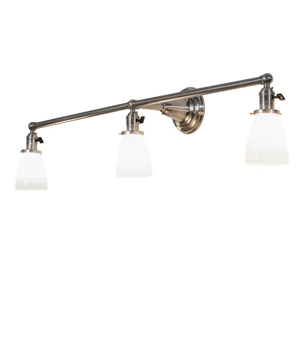 Recreating a golden era of style and charm; this fixture is inspired by Revival-styled homes. The exquisite Revival wall fixture impresses with three Oyster Bay Goblet-styled shades in White Opal blown glass. The shades are embraced by hardware and a linear frame designed and crafted with the exact details of old-world workmanship. This fixture features a handsome Brushed Nickel finish. Early electric lighting styles are popular in various locations; from Manhattan; New York City; to Wabash; Indiana and Cleveland; Ohio. The fixture is ideal for illuminating vanities in fine baths or as a wall sconce in corridors and other spaces. The Oyster Bay Goblet Vanity Light is included in our American-made; American-designed Revival Lighting Collection. Manufactured in Yorkville; New York. UL and cUL listed for dry and damp locations.