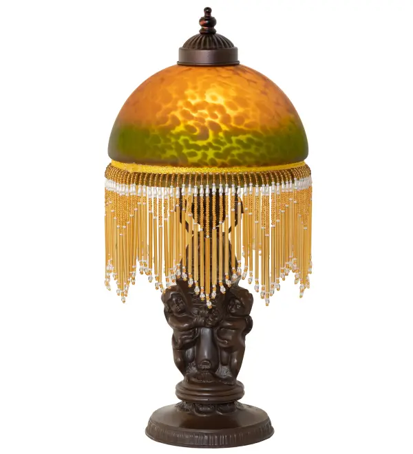 A charming nostalgic mini lamp that doubles as a decorative accent for nearly any room. This Roussillon features a stunning Amber and Green Mottled Glass shade color coordinated with delicate White and Cranberry glass beaded fringe. This Victorian-inspired shade combines a beautifully detailed lamp base in a Brass plated finish. The Roussillon Mini Lamp is featured in our American-designed, handcrafted Boudoir Lighting Collection. UL and cUL listed for dry locations. Each shade is a unique work of art with color variations based on natural ingredients inherent in the glass. Contact us if color matching is critical when ordering multiple items. Collection: Roussillon Finish: Mahogany Bronze Glass: Amber/Green Width: 8.00" Height: 17.00" Length: 8.00" Weight: 4.00 lb Number of Bulbs: 1 Maximum Wattage: 60.00 W Bulb Type: A19 Bulb Base: E26 Material: Zinc Country of Origin: CHINA Safety Rating: Dry