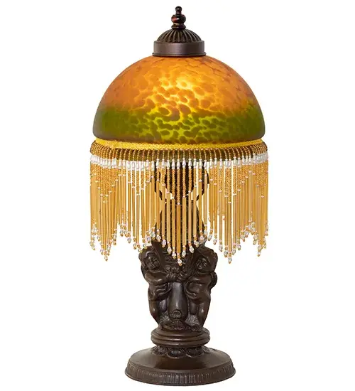 A charming nostalgic mini lamp that doubles as a decorative accent for nearly any room. This Roussillon features a stunning Amber and Green Mottled Glass shade color coordinated with delicate White and Cranberry glass beaded fringe. This Victorian-inspired shade combines a beautifully detailed lamp base in a Brass plated finish. The Roussillon Mini Lamp is featured in our American-designed, handcrafted Boudoir Lighting Collection. UL and cUL listed for dry locations. Each shade is a unique work of art with color variations based on natural ingredients inherent in the glass. Contact us if color matching is critical when ordering multiple items. Collection: Roussillon Finish: Mahogany Bronze Glass: Amber/Green Width: 8.00" Height: 17.00" Length: 8.00" Weight: 4.00 lb Number of Bulbs: 1 Maximum Wattage: 60.00 W Bulb Type: A19 Bulb Base: E26 Material: Zinc Country of Origin: CHINA Safety Rating: Dry - alternate view
