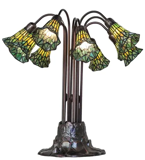 Inspired by the famous Tiffany design from the early 1900s. This table lamp features 10 stunning Green stained glass shades created using the famous Meyda Tiffany copperfoil construction technique. An elegant cast metal Lily pad base embraces the shades with fitters finished by hand in Mahogany Bronze. The Tiffany Pond Lily Light Table Lamp is included in our American-designed, handcrafted Stained Glass Lighting Collection. UL and cUL listed for dry locations. Each shade is a unique work of art with color variations based on natural ingredients inherent in the glass. Please contact us if color matching is critical when ordering multiple items. Collection: Stained Glass Pond Lily Finish: Mahogany Bronze Glass: Green Stained Glass Width: 25.00" Height: 24.00" Length: 25.00" Weight: 17.00 lb Number of Bulbs: 10 Maximum Wattage: 25.00 W Bulb Type: B10 Bulb Base: E12 Material: Zinc Country of Origin: CHINA Safety Rating: Dry - alternate view