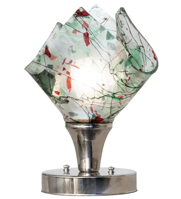 Contemporary, fun, transitional, elegant, and creative. Nothing compares to this stunning art piece, which features high-fired fused glass in Leaf and Avocado Greens and Cerulean and Red on a Clear background transformed into an abstract handkerchief shape. This lamp is complemented with a Polished Nickel finish. The Tossalad Confetti Handkerchief Mini Lamp is included in our American-made, American-designed, handcrafted Abstract Lighting Collection. Manufactured in Yorkville, New York. UL and cUL listed for dry locations. Collection: Tossed Salad Finish: Polished Nickel Glass: Green/Red/Clear Speckled Glass Width: 9.00" Height: 10.00" Length: 9.00" Weight: 3.00 lb Number of Bulbs: 1 Maximum Wattage: 60.00 W Bulb Type: A15 Bulb Base: E26 Material: Steel Country of Origin: USA Safety Rating: Dry