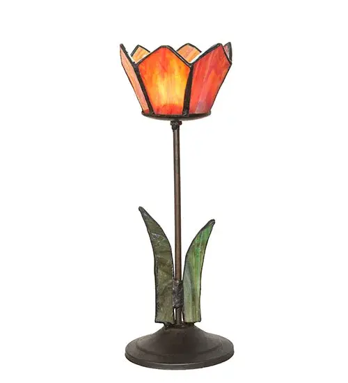 This charming tealight holder is created using the famous Meyda Tiffany copperfoil construction technique. The floral petals are featured in Pink stained? glass while they are accented with Green stained glass leaves below. The figure sits on a Craftsman Brown fnished base. The tealight tis ideal as an illuminating accent piece on mantels; credenzas; occasional tables; and other spaces in fine homes. The Radient Blossom Tealight Holder is included in our American-designed Stained Glass Collection. Each lamp is a unique work of art with color variations based on natural ingredients inherent in the glass.