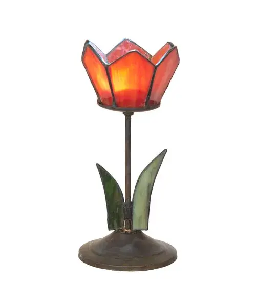 This charming tealight holder is created using the famous Meyda Tiffany copperfoil construction technique. The floral petals are featured in Pink stained glass while accented with Green stained glass leaves below. The figure sits on a Craftsman Brown finished base. The tealight is ideal as an illuminating accent piece on mantels; credenzas; occasional tables; and other spaces in fine homes. The Radient Blossom Tealight Holder is included in our American-designed; handcrafted Stained Glass Collection. Each lamp is a unique work of art with color variations based on natural ingredients inherent in the glass - alternate view