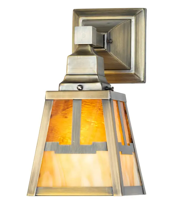 An Arts and Crafts design is featured on this wall sconce which is designed with a Valley View motif on a shade that features Honey Amber art glass on the upper section and Beige Art Glass on the lower section. The Solid Brass wall fixture is enhanced with an Antique Brass finish and inspired by Mission-styled homes in Santa Fe; New Mexico; and Highland Park and Santa Barbara in California. This wall sconce is ideal for use in hallways; dining areas; and other rooms in residential; hospitality; and commercial settings. The Mission Valley View Wall Sconce is included in our American-made; American-designed; handcrafted; award-winning Mission Lighting Collection and manufactured in Yorkville; NY. UL and cUL listed for dry and damp locations.