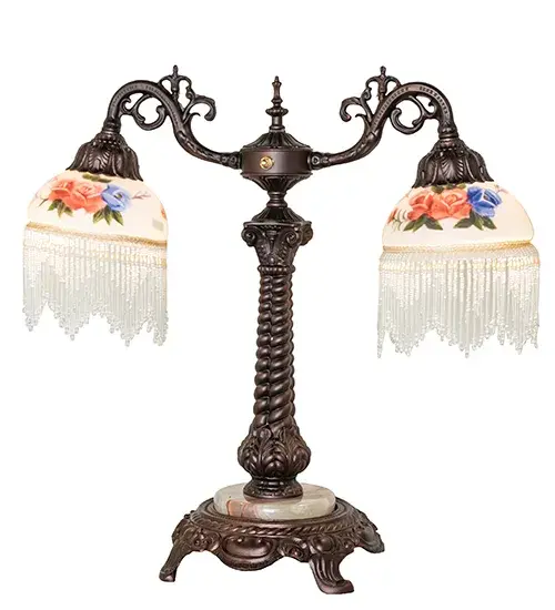 A charming nostalgic accent lamp that will add beauty to your rooms. This Roussillon lamp features two stunning White Art Glass shades with Rose Bouquet Hand-Painted designs that are color-coordinated with delicate Clear glass beaded fringe. An elegant cast metal base in a Mahogany Bronze finish with a White Marble accent embraces the Victorian-inspired shades. Perfect for placing in picture windows, living rooms, and other spaces in fine homes from Richmond Hill in Queens, New York, to Woodruff Place in Indianapolis, Indiana, to Guthrie, Oklahoma. The Roussillon 2 Light Table Lamp is featured in our American-designed, handcrafted Boudoir Lighting Collection. UL and cUL listed for dry locations. Each shade is a unique work of art with color variations based on natural ingredients inherent in the glass. Collection: Roussillon Finish: Mahogany Bronze Glass: Hand Painted Glass Width: 21.00" Height: 20.00" Length: 21.00" Weight: 13.00 lb Number of Bulbs: 2 Maximum Wattage: 60.00 W Bulb Type: A15 Bulb Base: E26 Material: Zinc Country of Origin: CHINA Safety Rating: Dry - alternate view