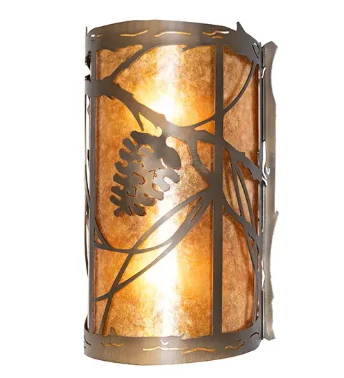 Invite the beauty of nature into your home with a charming wall fixture featuring metal accents designed as a Pinecone, Pine needles, and branches. Experience the warm beauty of an Amber Mica diffuser enhanced with an Antique Copper finish. The ADA-compliant fixture complements the matching center sconce 272362 and left sconce 261021. The Whispering Pines Wall Sconce is featured in our American-made, American-designed, handcrafted Nature Inspired Collection. It was manufactured in Yorkville, New York. It is UL and cUL listed for dry and damp locations. Collection: Whispering Pines Finish: Antique Copper Glass: Amber Mica Width: 8.00" Height: 13.00" Length: 4.00" Weight: 3.00 lb Number of Bulbs: 2 Maximum Wattage: 60.00 W Bulb Type: A19 Bulb Base: E26 Material: Steel Country of Origin: USA Safety Rating: Damp - alternate view
