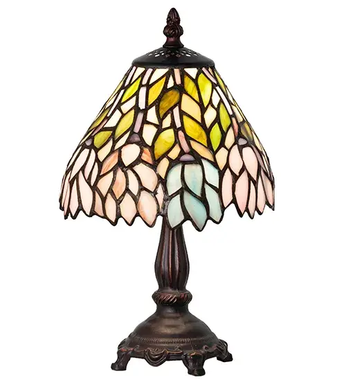 The Wisteria lamp features cascading blossoms in variegated hues of Blue, Pink and Purple art glass that are accented with Spring Green leaves. Designed with an undulating border, this beautiful art glass shade offers a complex artistic pattern that is complemented with an exquisite base in a Mahogany Bronze finish. Custom colors, styles, sizes and bulb options are available. UL and cUL listed for dry locations. Collection: Wisteria Finish: Mahogany Bronze Glass: Stained Glass Width: 7.00" Height: 13.00" Length: 7.00" Weight: 2.00 lb Number of Bulbs: 1 Maximum Wattage: 60.00 W Bulb Type: B10 Bulb Base: E12 Material: Zinc Country of Origin: CHINA Safety Listing: Dry Safety Rating: Dry - alternate view