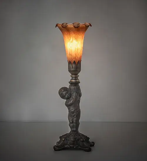 Inspired by the famous Tiffany design from the early 1900s. This mini lamp features a stunning shade mouth blown of Amber Favrile-style art glass. The Pond Lily shade is embraced by an elegant cast base featuring a charming cherub finished by hand in Antique Brass. The Pond Lily Mini Lamp is featured in our American-designed; handcrafted Favrile Glass Collection. UL and cUL listed for dry locations. Each shade is a unique work of art with color variations based on natural ingredients inherent in the glass.