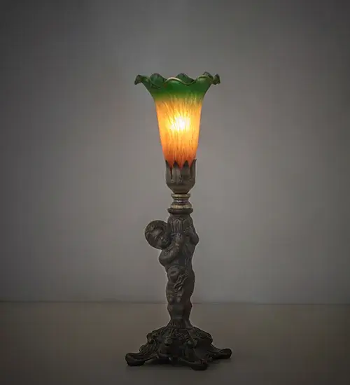 Inspired by the famous Tiffany design from the early 1900s. This mini lamp features a stunning shade mouth blown of Amber Green Favrile-style art glass. The Pond Lily shade is embraced by an elegant cast base featuring a charming cherub finished by hand in Antique Brass. The lamp is ideal for placement in picture windows and desks in fine homes from Utica; New York; to Topeka; Kansas. The?Amber Green Tiffany Pond Lily Cherub Mini Lamp is featured in our American-designed; handcrafted Favrile Glass Collection. UL and cUL listed for dry locations. Each shade is a unique work of art with color variations based on natural ingredients inherent in the glass.