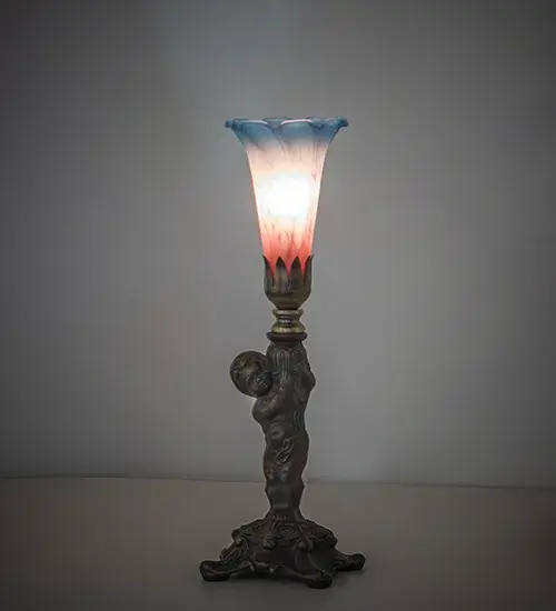 Recreating the famous Tiffany design from the early 1900s. This mini lamp features a stunning shade mouth blown of Pink and Blue Favrile-style art glass. The Pond Lily shade is embraced by an elegant cast metal base featuring a charming cherub finished by hand in Antique Brass. This lamp is ideal for illuminating picture windows; credenzas; and desktops in fine homes and hotels from Buffalo-Cheektowaga; New York; to the Providence-Warwick; Rhode Island region. The Pond Lily Mini Lamp is included in our American-designed; handcrafted Favrile Glass Collection. UL and cUL listed for dry locations. Each shade is a unique work of art with color variations based on natural ingredients inherent in the glass.