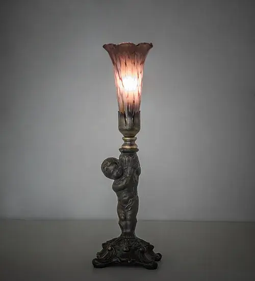 Recreating the famous Tiffany design from the early 1900s. This mini lamp features a stunning shade mouth blown of Purple Iridescent Favrile-style art glass. The Pond Lily shade is embraced by an elegant cast base featuring a charming cherub finished by hand in Antique Brass. This lamp is ideal for illuminating picture windows; credenzas; and desktops in fine homes and hotels from Buffalo-Cheektowaga; New York; to the Providence-Warwick; Rhode Island region. The Pond Lily Mini Lamp is featured in our American-designed; handcrafted Favrile Glass Collection. UL and cUL listed for dry locations. Each shade is a unique work of art with color variations based on natural ingredients inherent in the glass.