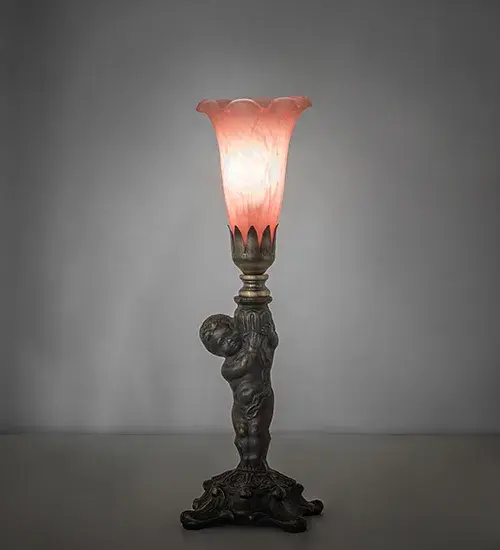 Inspired by the famous Tiffany design from the early 1900s. This mini lamp features a stunning Pink Favrile-style art glass shade that is embraced by an elegant cast base featuring a cherub finished by hand in Mahogany Bronze. The lamp is ideal for illuminating a picture window; end table; or credenza in fine homes from New Castle; Delaware; to Monterey; California. The Pond Lily Table Lamp is featured in our American-designed; handcrafted Favrile Glass Lighting Collection. UL and cUL listed for dry locations. Each shade is a unique work of art with color variations based on natural ingredients inherent in the glass.